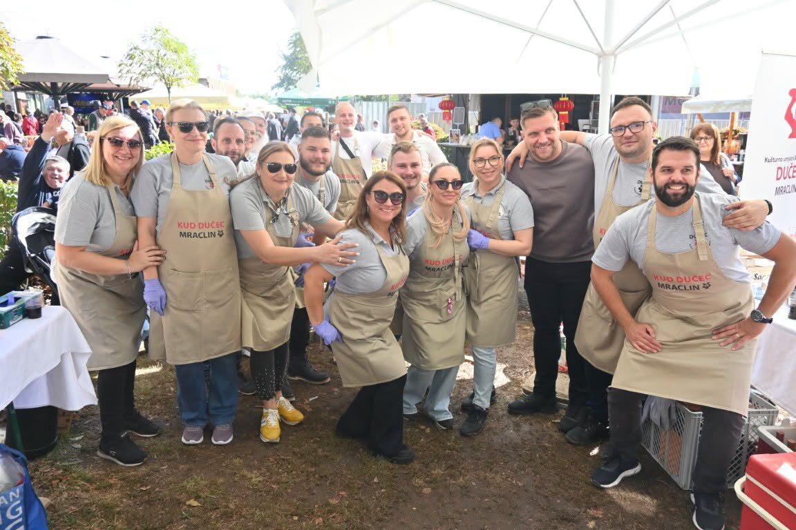 Members of the association in aprons at a community food event